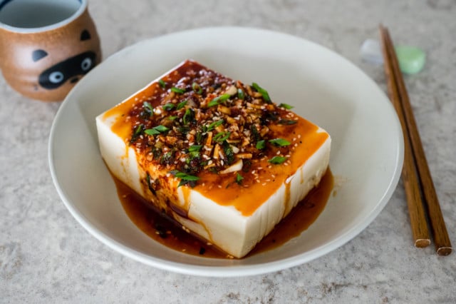 Spicy cold tofu in a bowl with chopsticks